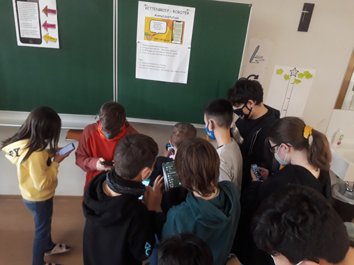 SchülerInnen der MS Frastanz probieren mit ihren Smartphones den Kettenbrief-Bot aus
